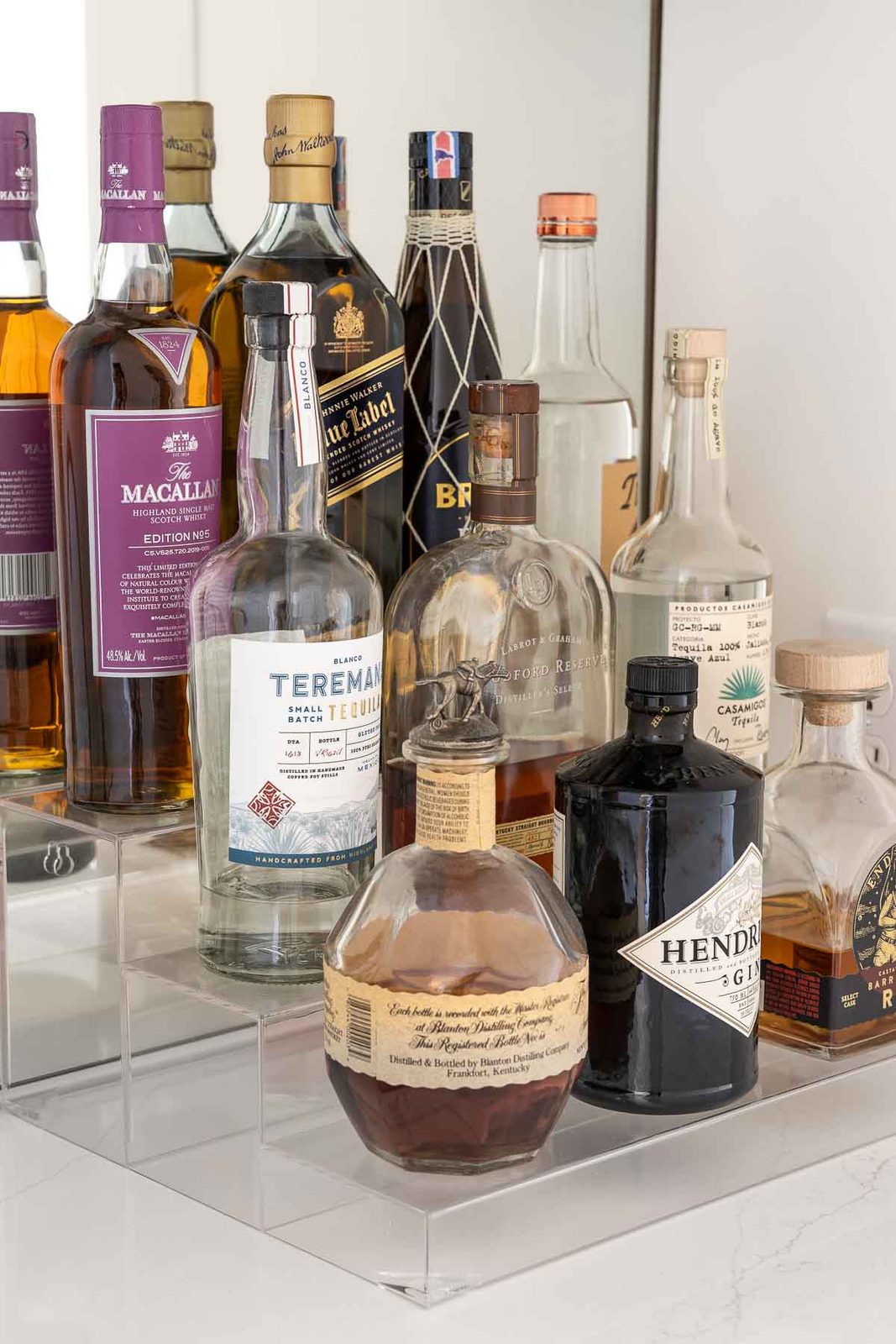 Acrylic riser for alcohol bottles