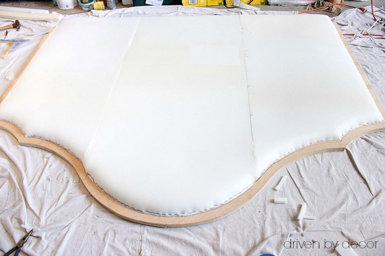 Foam stapled to plywood in preparation for upholstering and adding nailheads