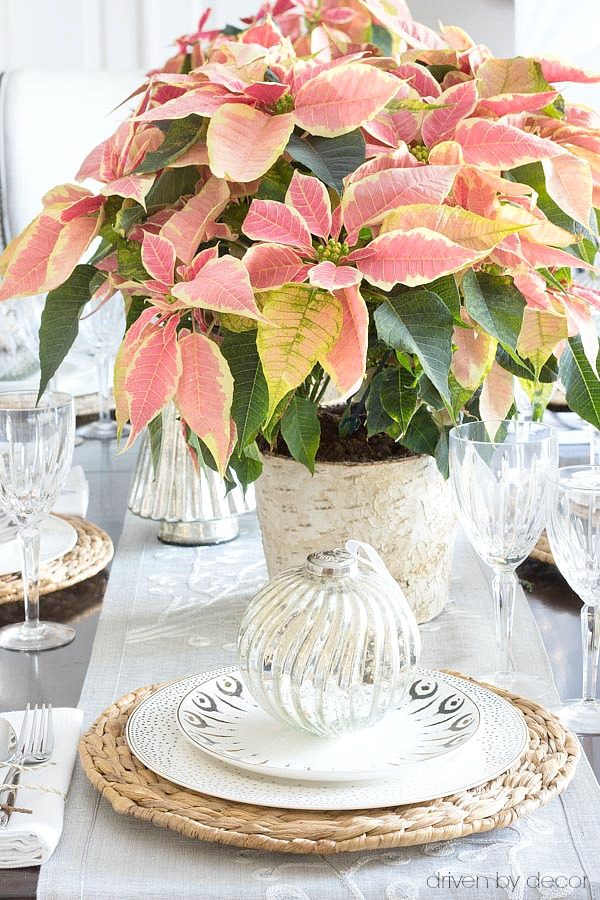 An oversized ornament adorns each plate on this Christmas tablescape