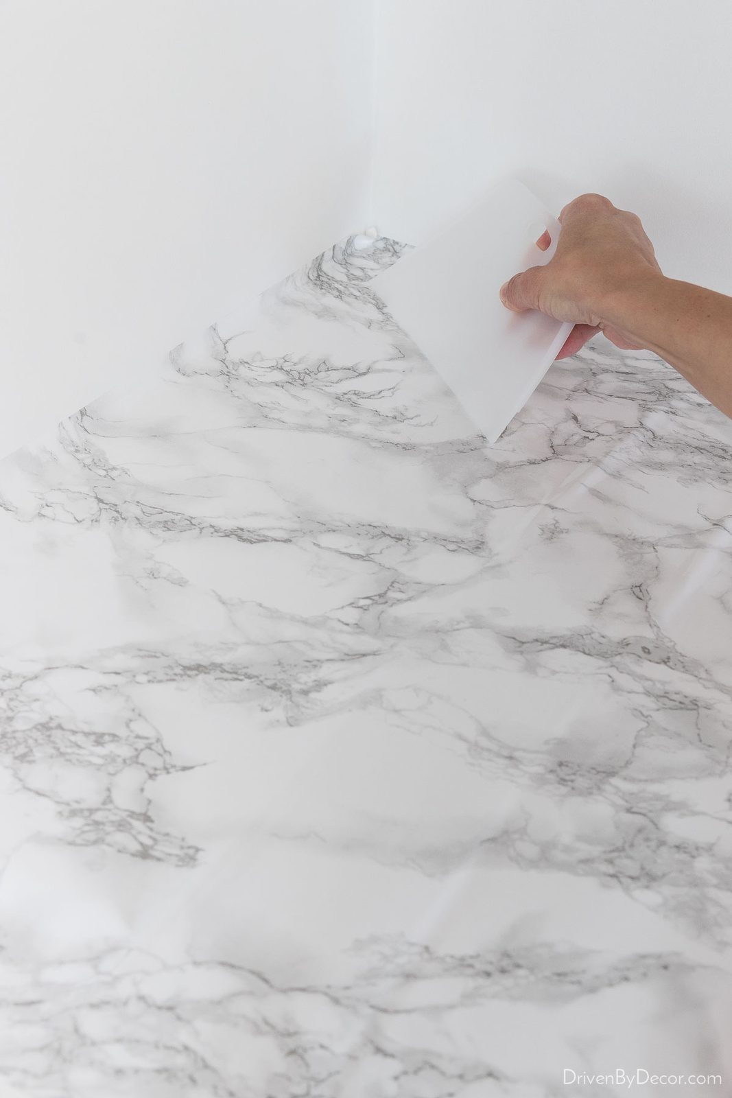 Place the first corner of contact paper down and smooth it out on your countertops
