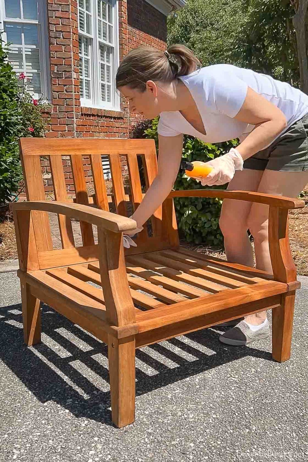 Applying teak conditioner to outdoor teak chair