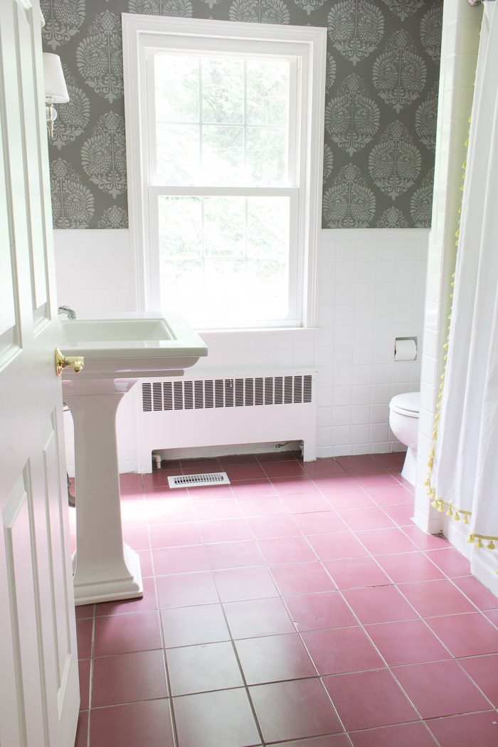"Before" of bathroom before ceramic floor tiles were painted gray. Such a huge difference!