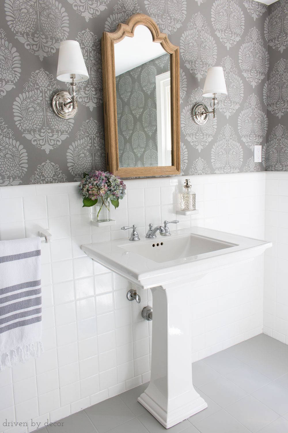Great tips for how high and how far apart to hang sconces in a bathroom on either side of the mirror. Lots of other helpful bathroom measurement tips in this post - check it out!