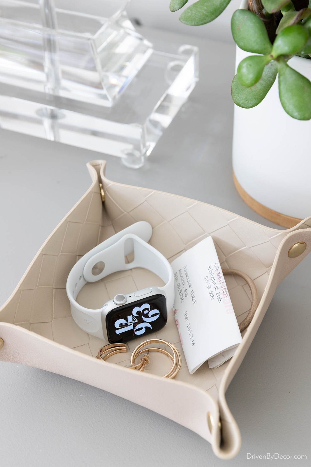 Valet tray on dresser used as bedroom drop zone