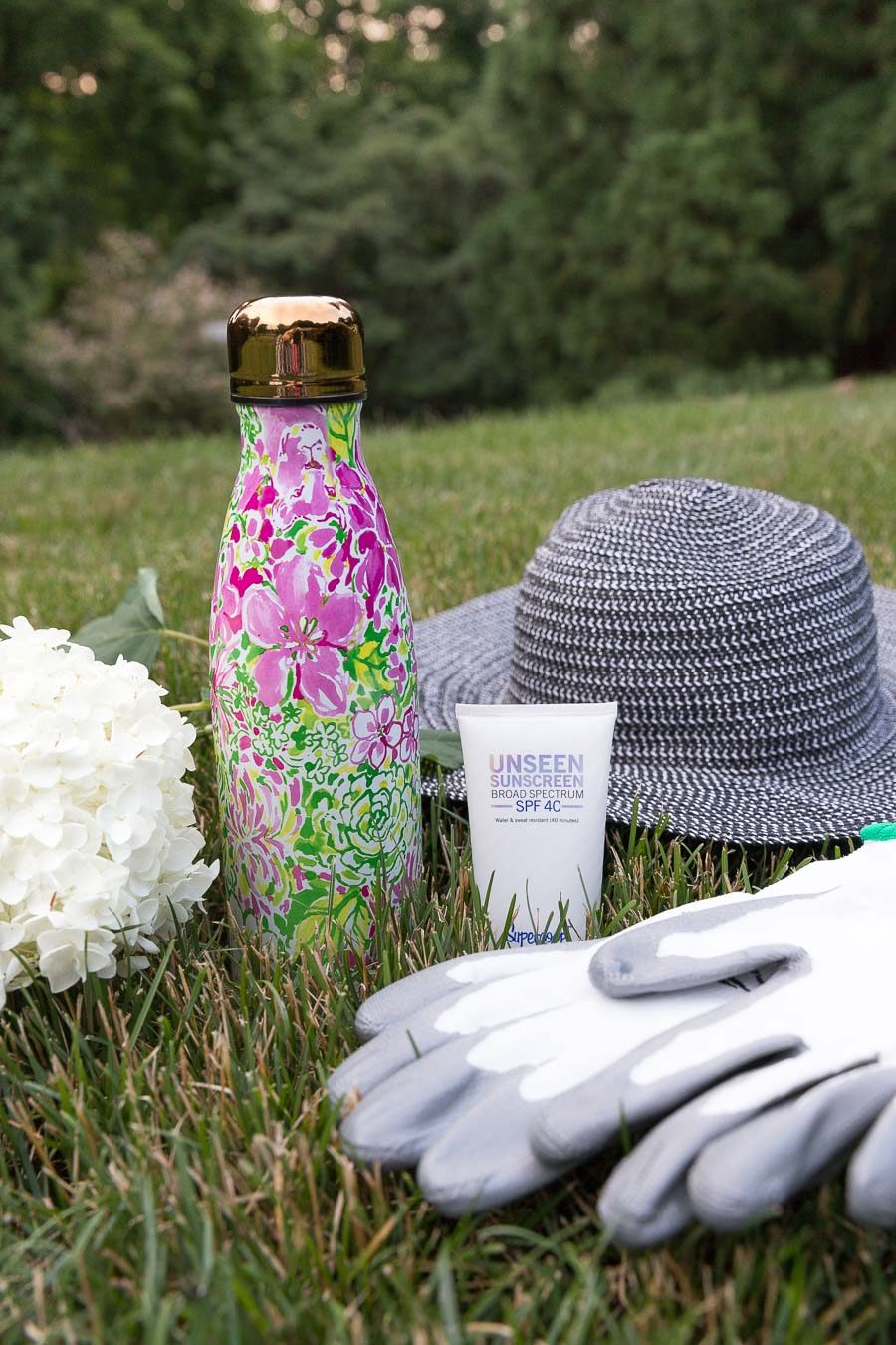 My gardening favorites - invisible sunscreen, floppy hat, gloves, and water bottle - I've linked the exact items in my post!