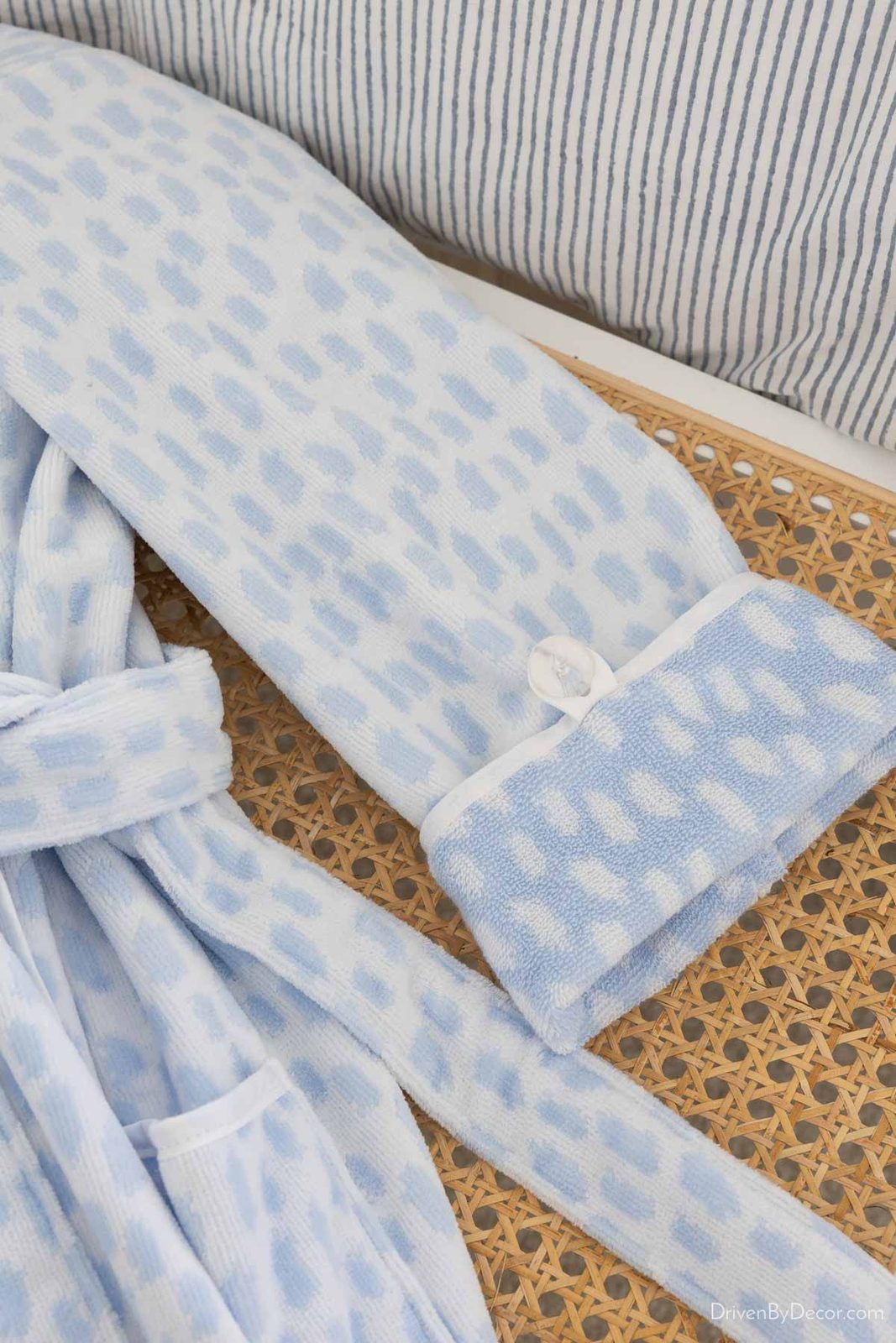 Sleeve of plush robe showing button that keeps rolled up sleeves in place
