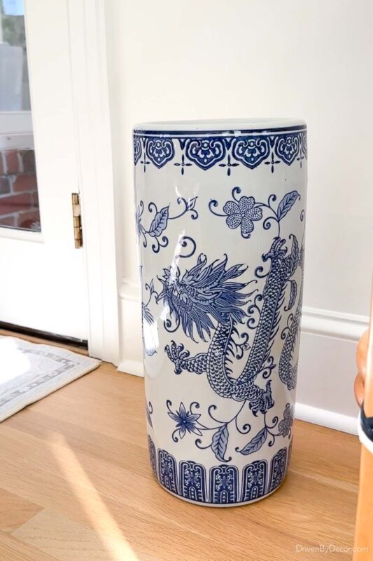 Blue and white patterned umbrella stand next to door