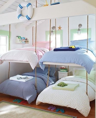 Bunk beds suspended from ceiling with rope