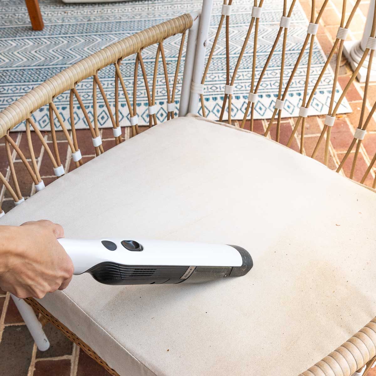 Vacuuming pollen off of outdoor furniture cushions