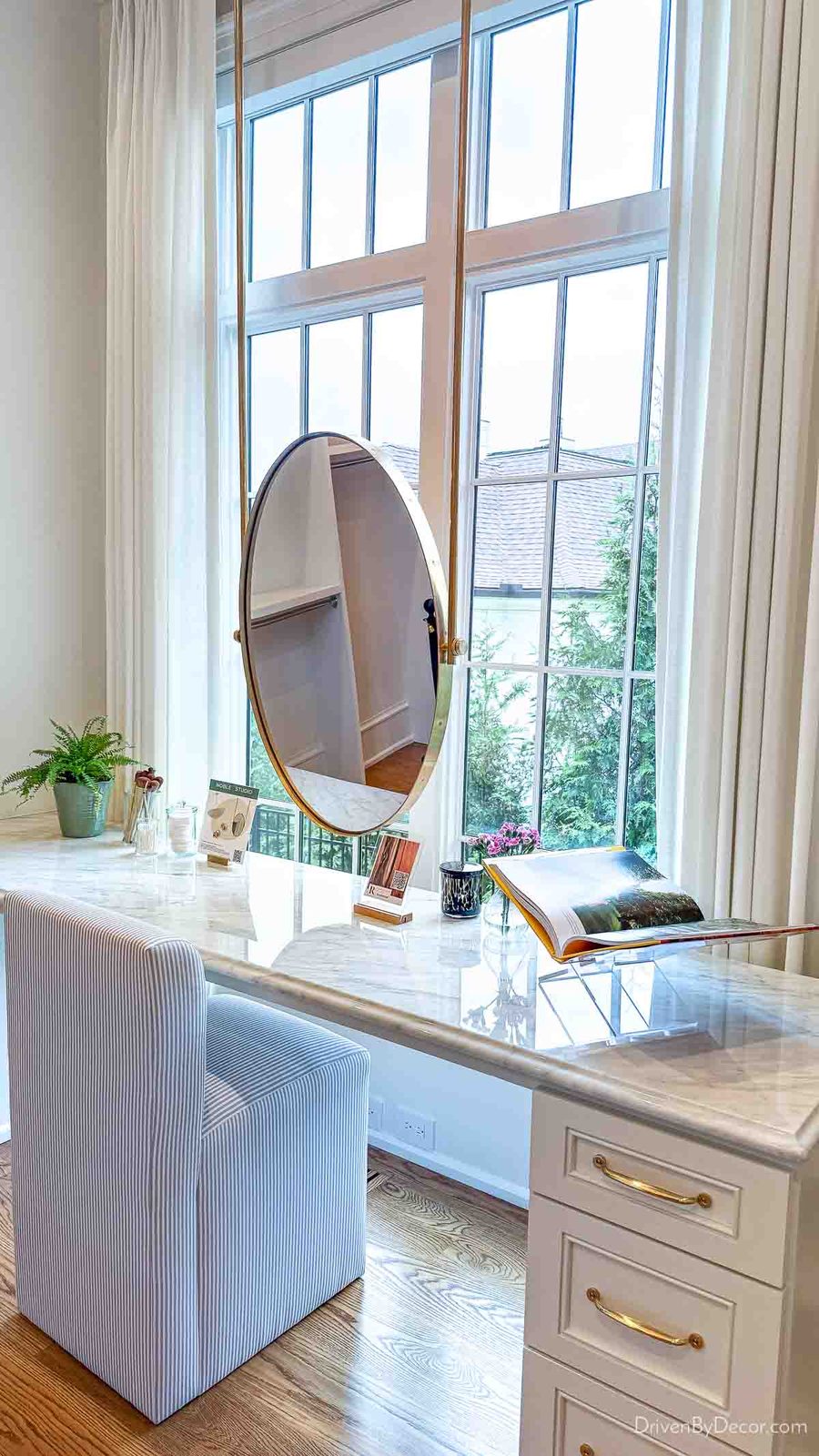 Sit down vanity with mirror in front of window in closet