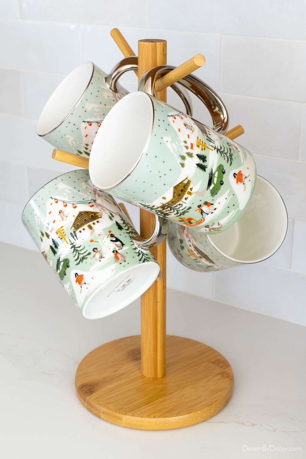 Mug tree holding Christmas themed mugs