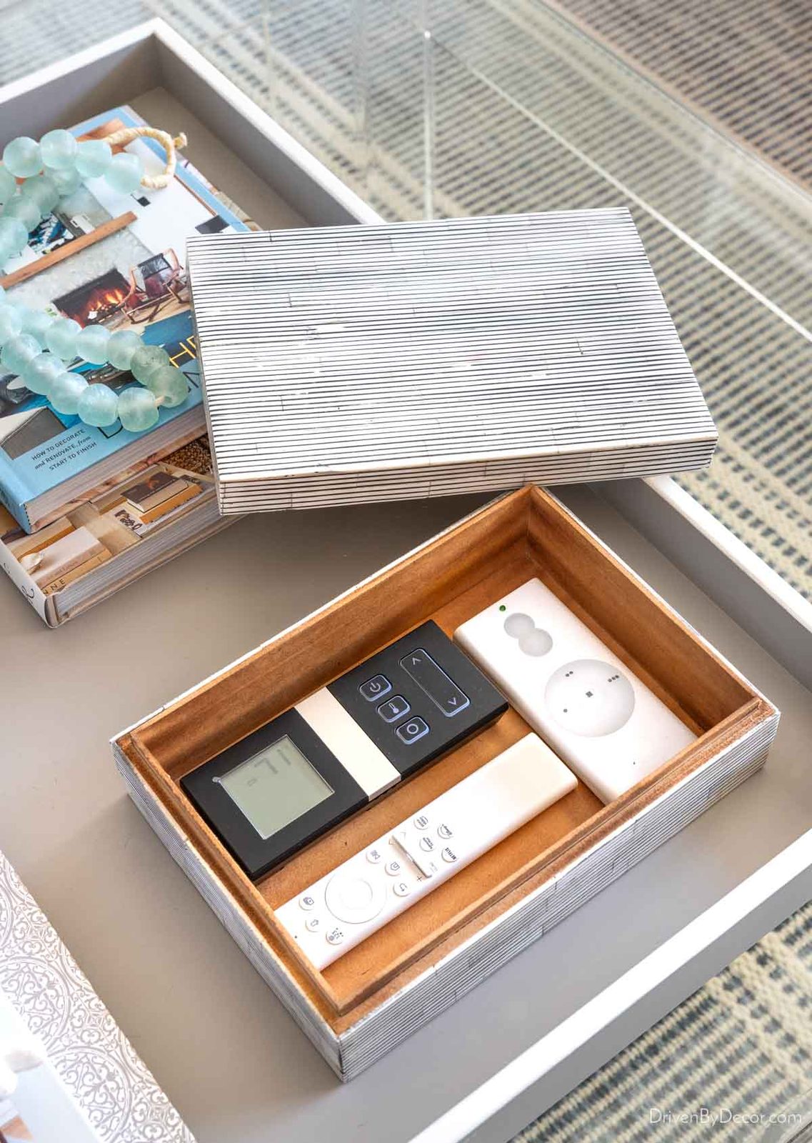 Decorative pinstripe box holding remote controls