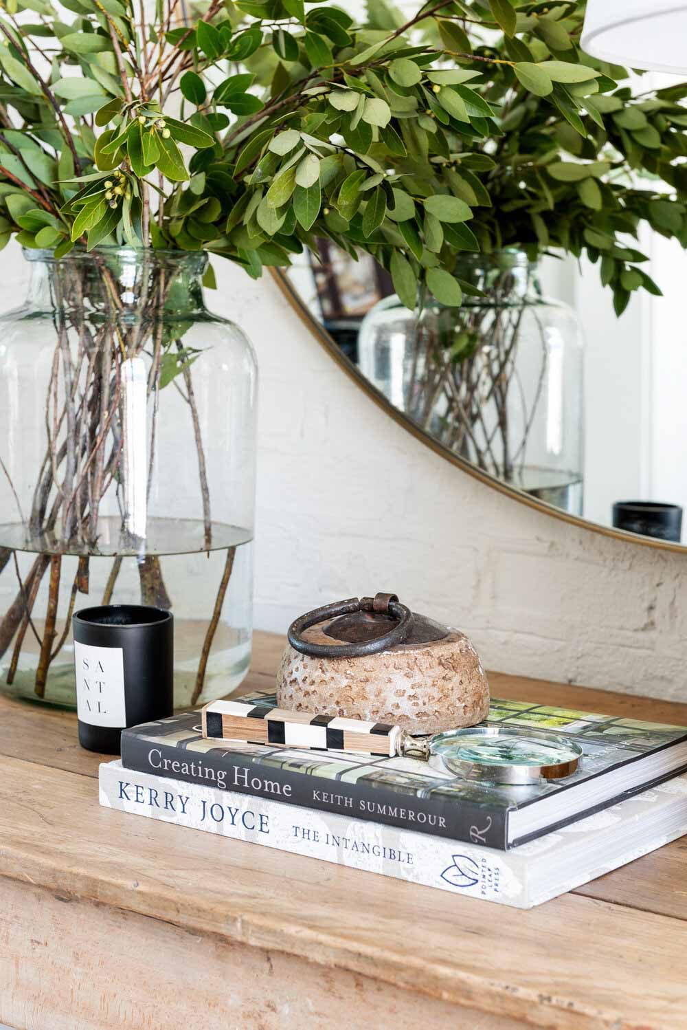 Magnifying glass on two stacked books on a console