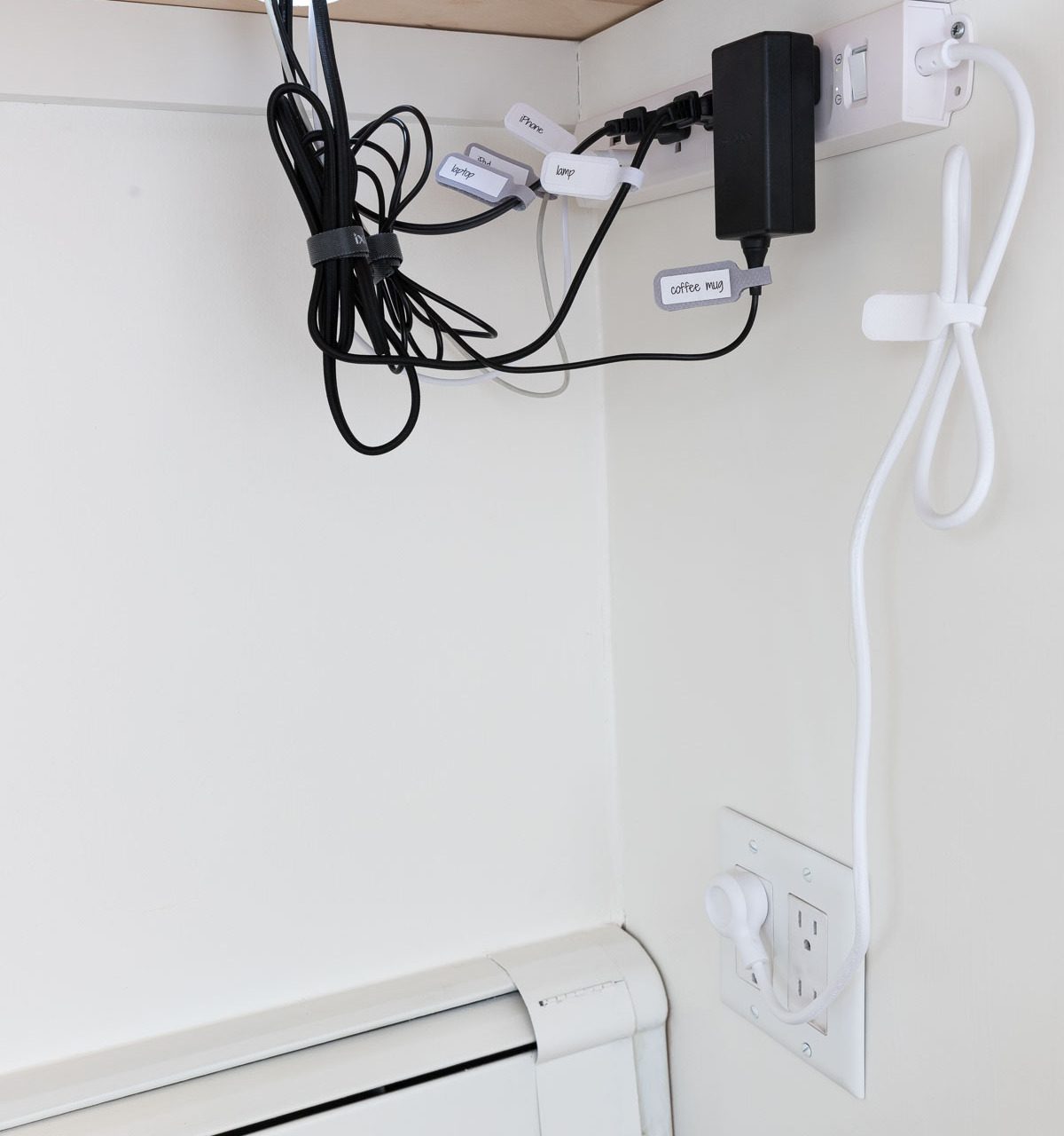 How we corral our cords under our desk - one of my favorite desk organization ideas!