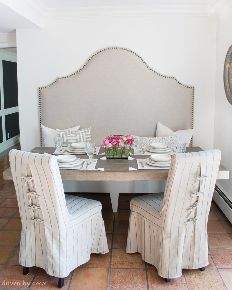 Our breakfast nook with a high backed banquette and slipcovered chairs with ties in the back!