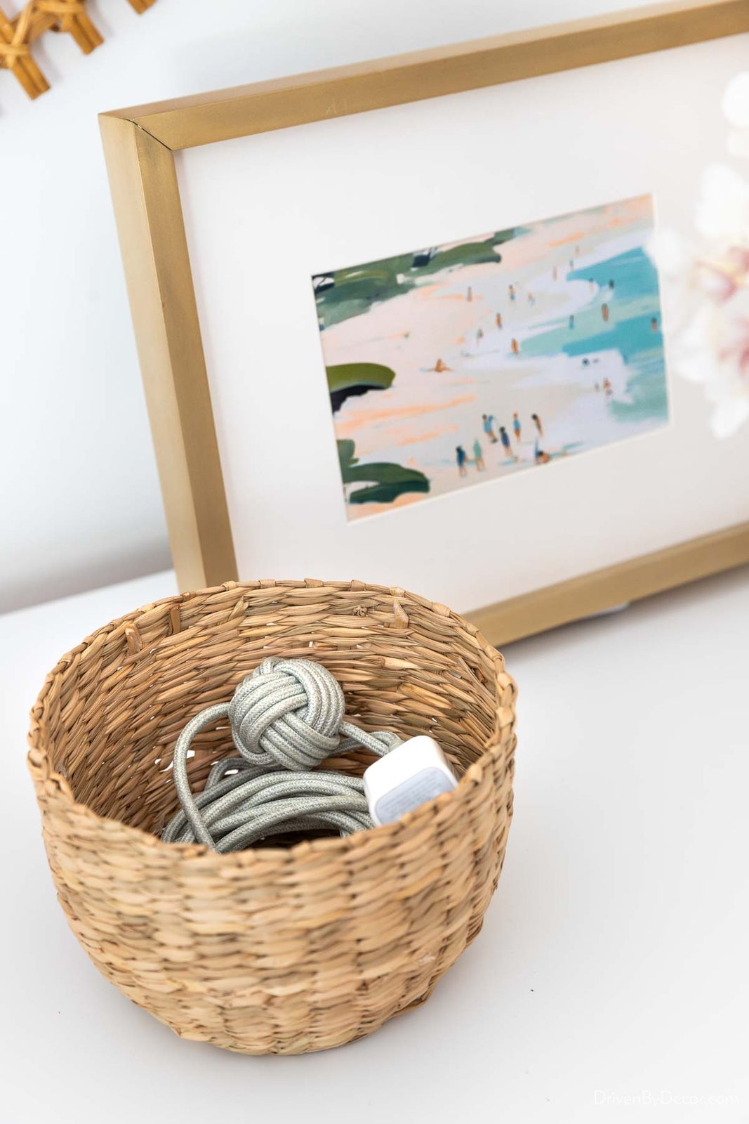 Charging cord in small basket on dresser