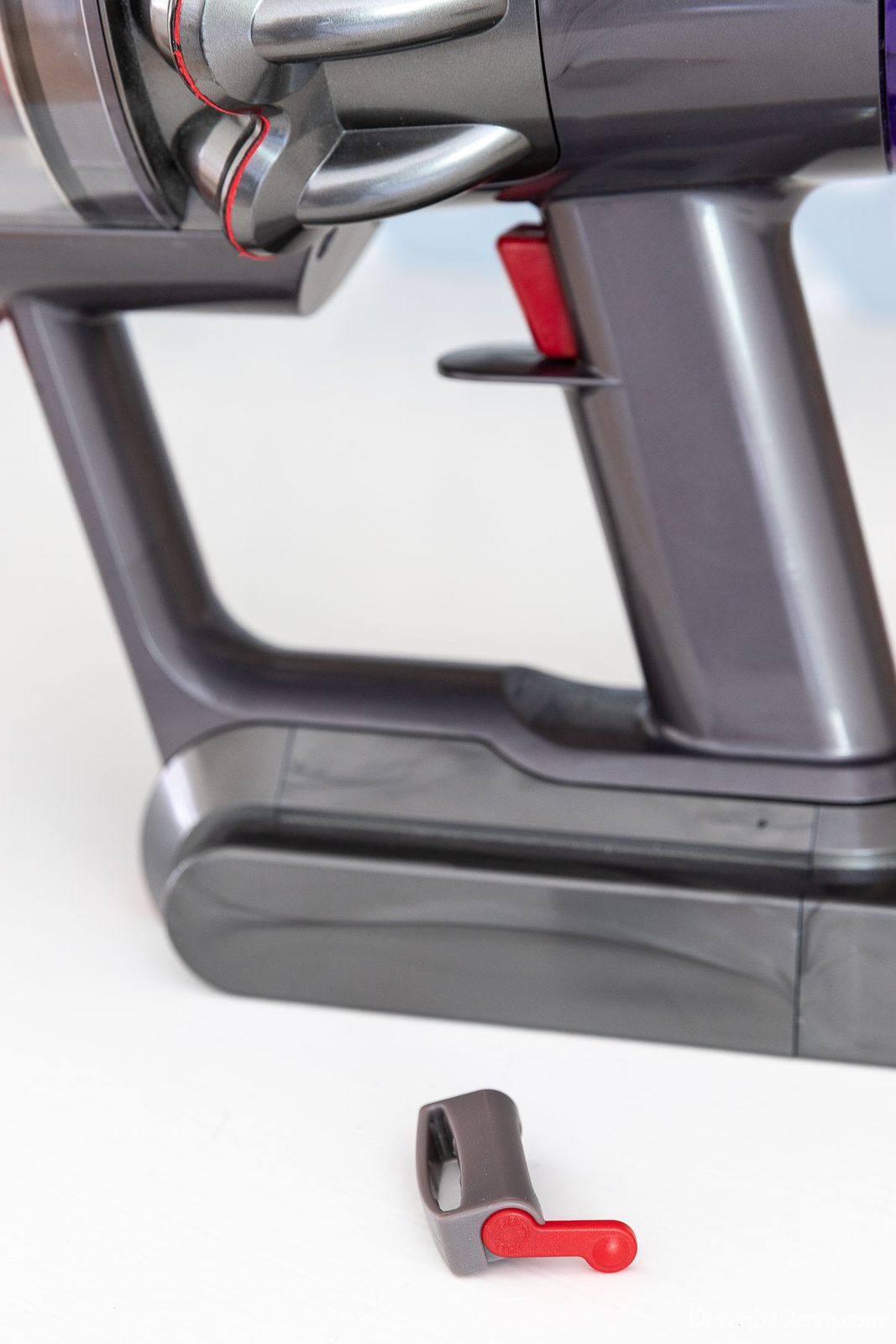 Clamp to slide on Dyson trigger to keep it on