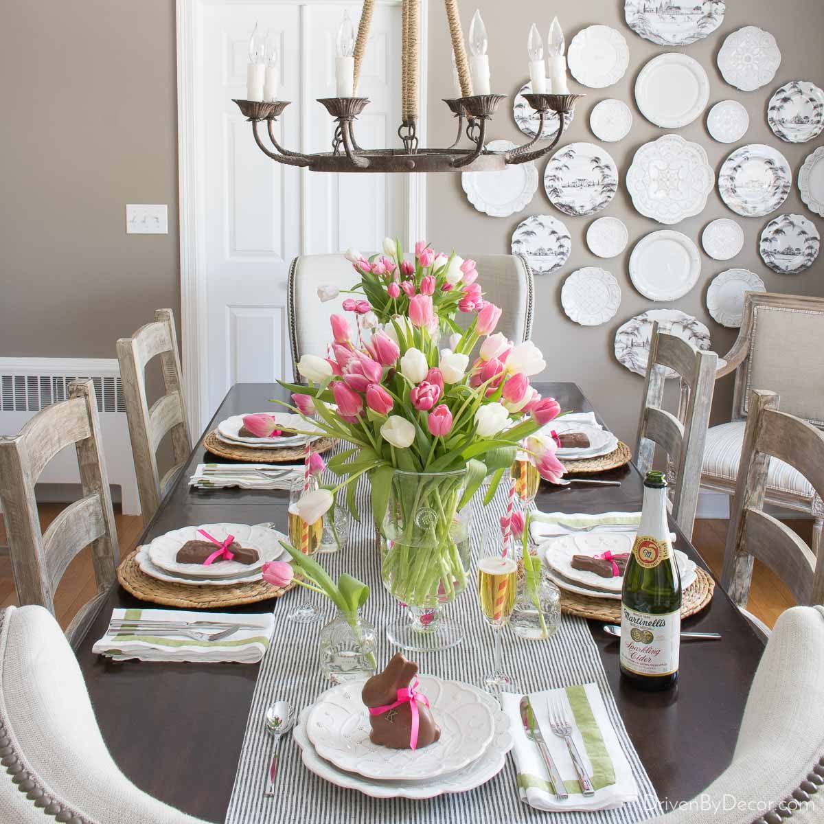Easter table decor ideas - vase of tulips and chocolate bunnies on plates in dining room