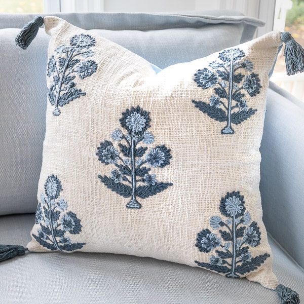 Cream pillow with blue embroidery