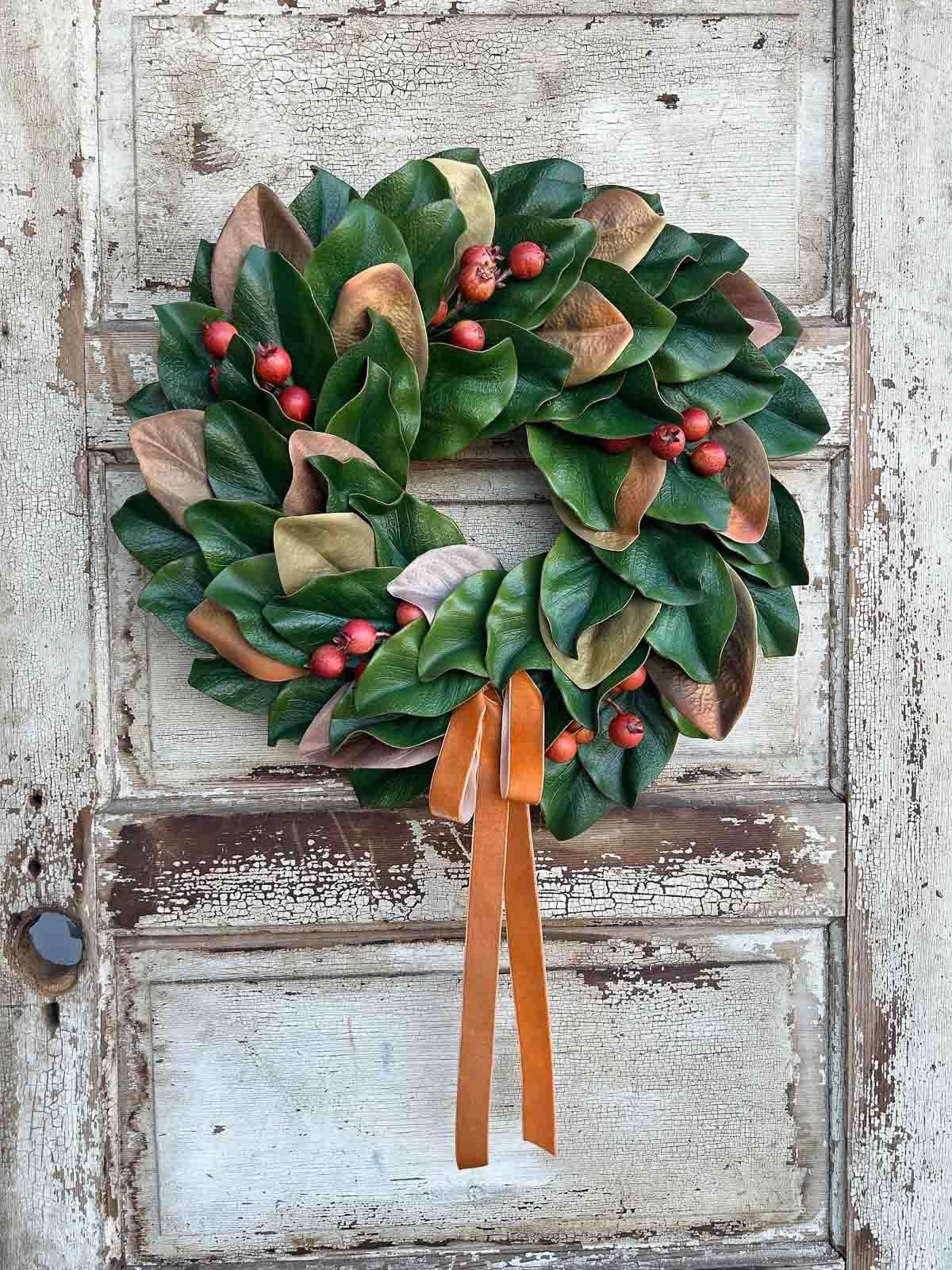 Stunning magnolia wreath with berries and a velvet bow