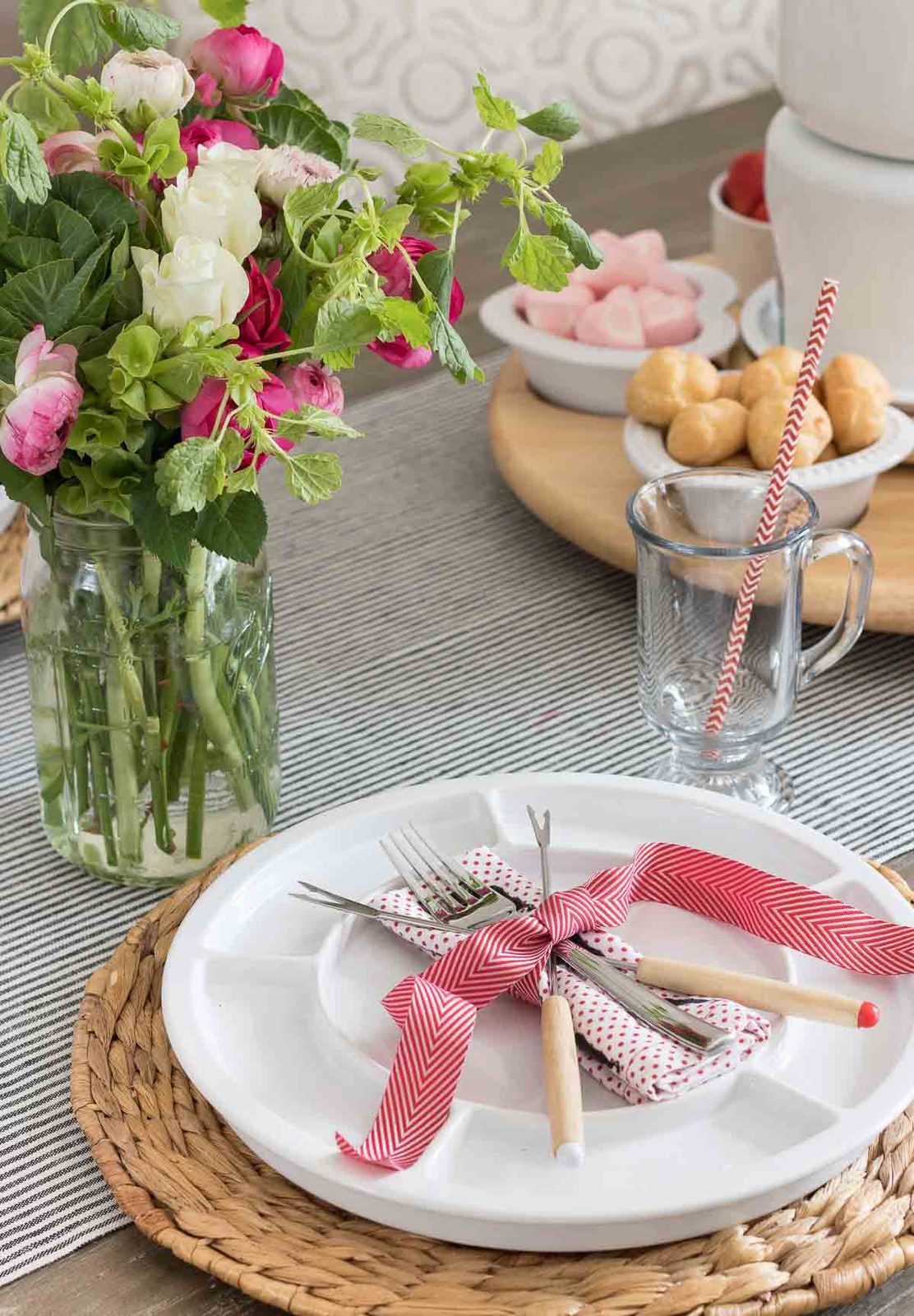 Fondue forks crossed and tied with ribbon on fondue plate