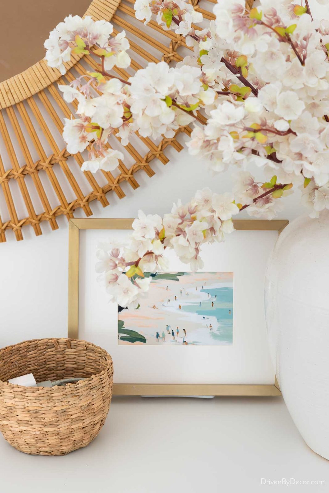 Framed art print as small round basket as dresser decor
