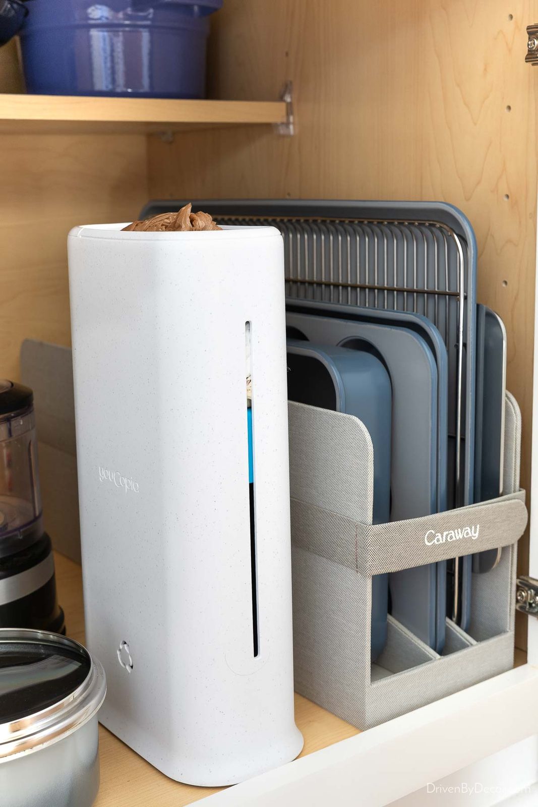 White plastic bag dispenser inside cabinet for kitchen organization