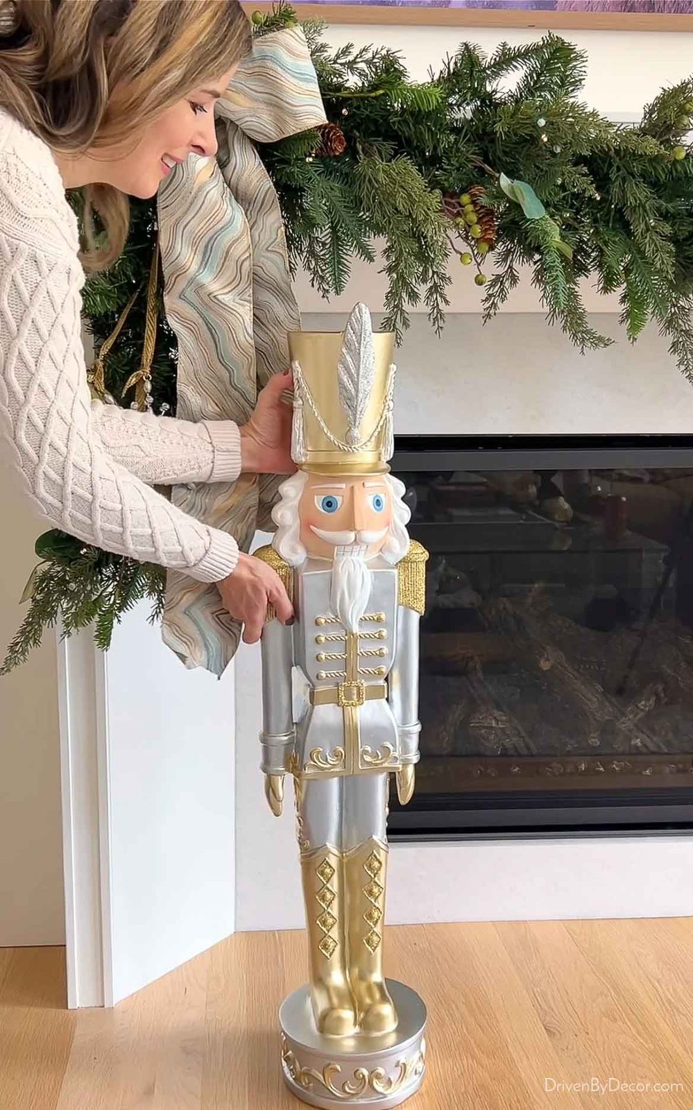Gold and silver nutcracker next to fireplace