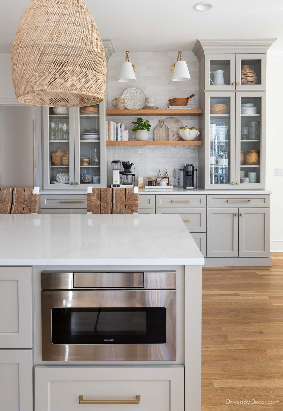 Gray island and coffee bar cabinets in remodeled kitchen