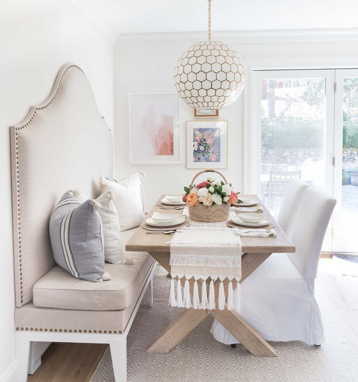 Kitchen eat-in area with built-in banquette and capiz pendant over table