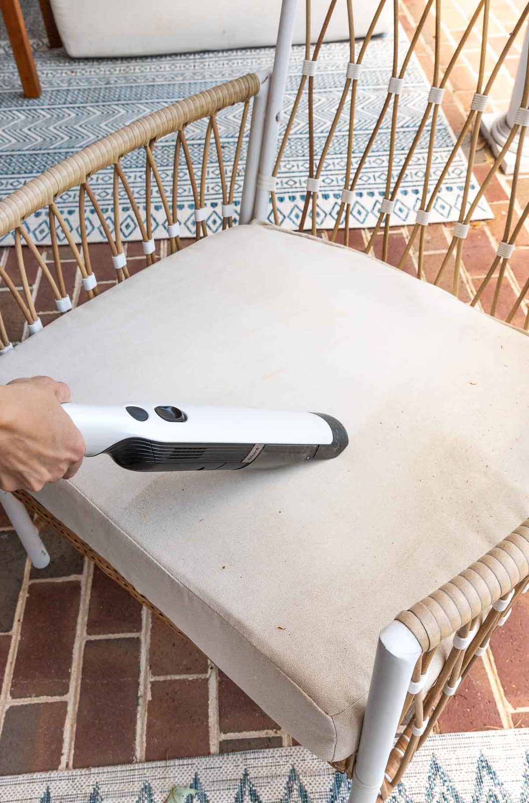 Vacuuming as first step in cleaning outdoor cushions