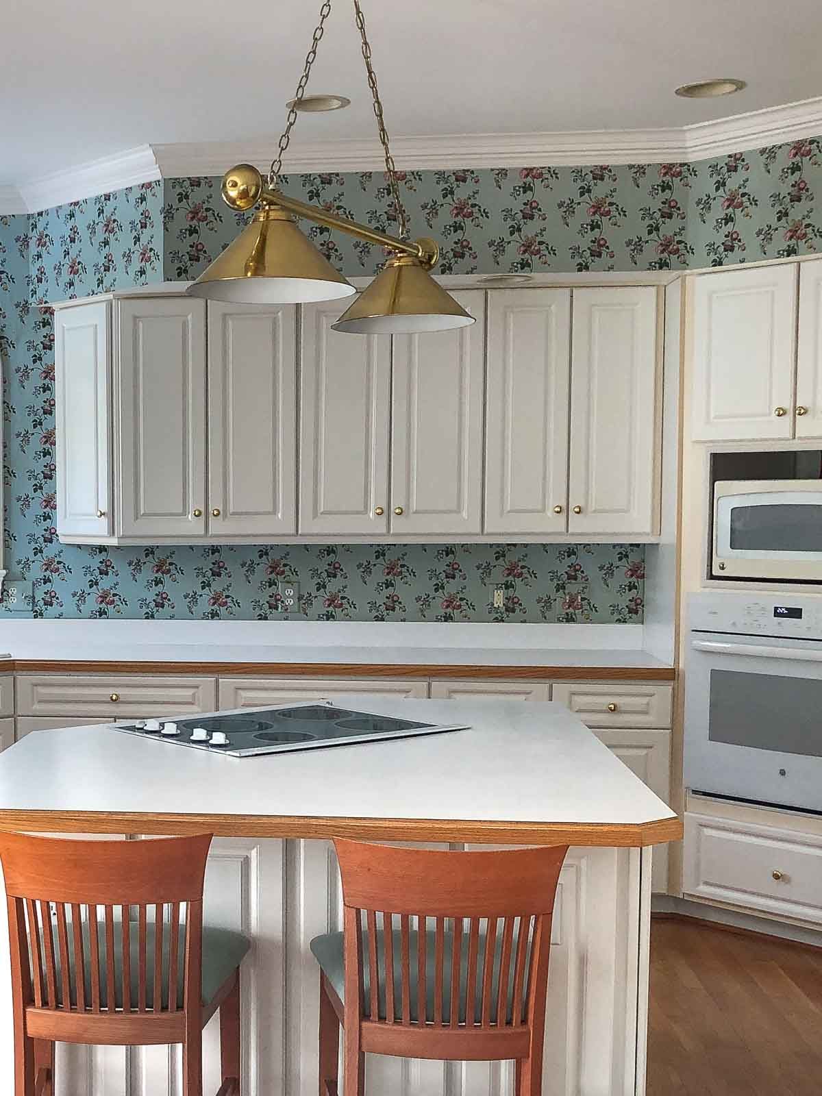 Dated kitchen with old floral wallpaper