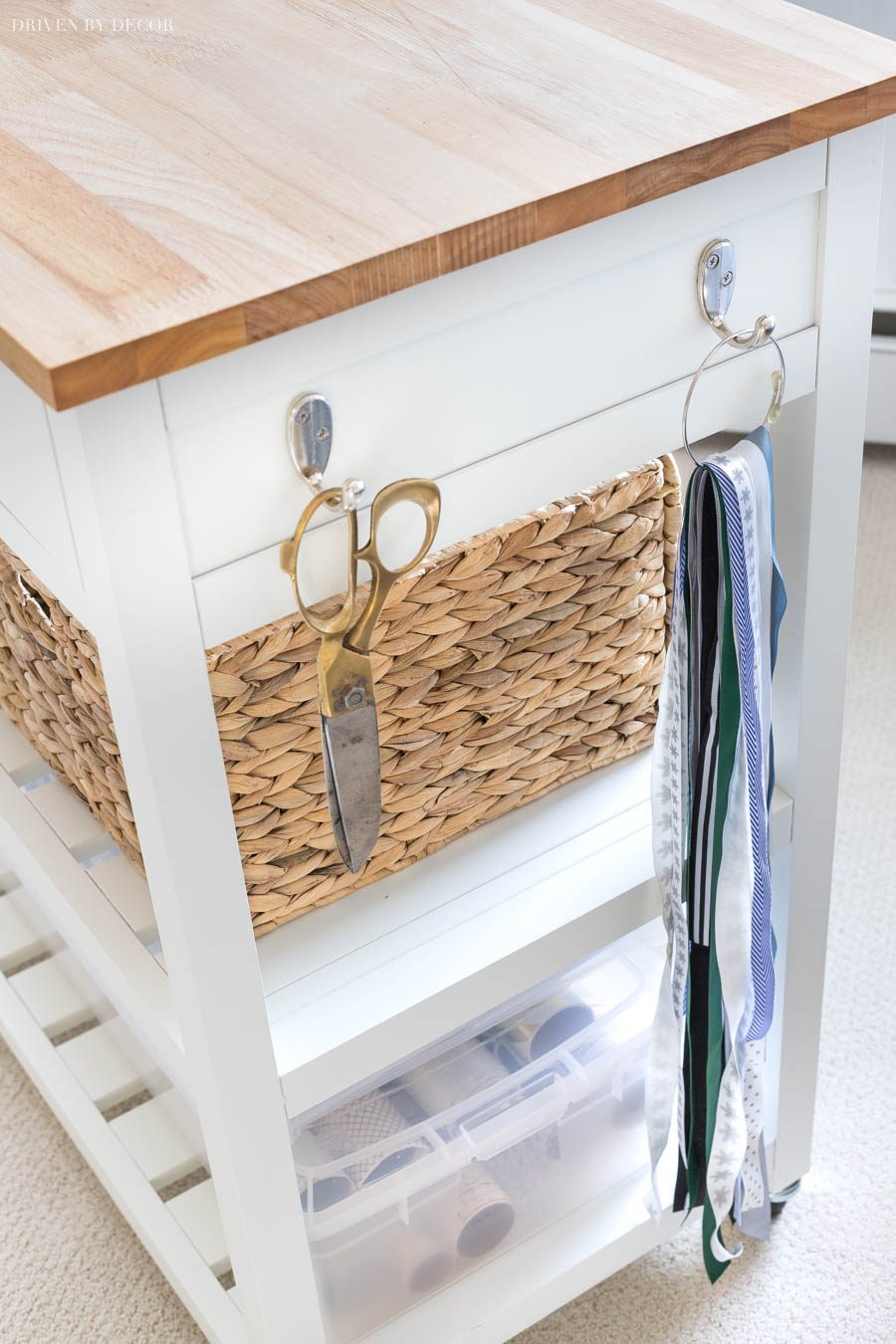 Such a clever use of this cart for a gift wrapping station! Love how the hooks are used for scissors and extra ribbon pieces.