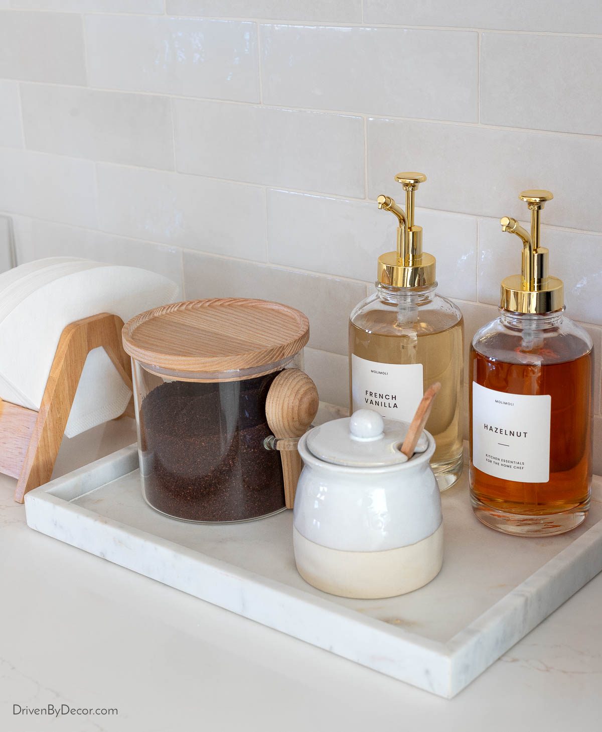 Kitchen coffee bar tray with coffee, syrups, and sugar bowl