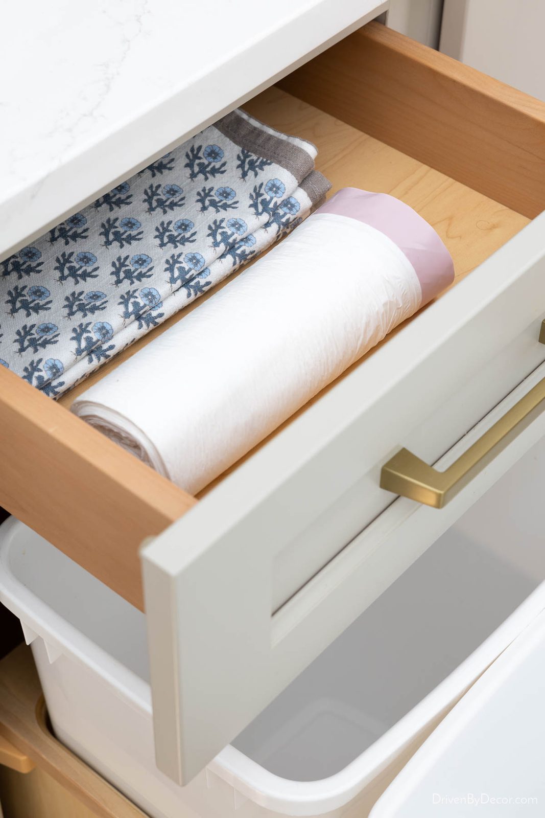 Kitchen drawer holding garbage bags and napkins