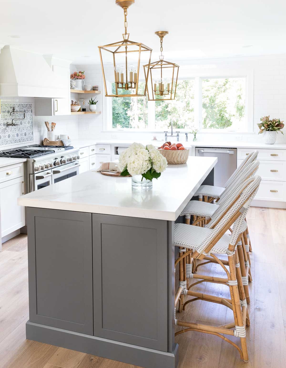 Kitchen island with a pair of gold lantern pendants