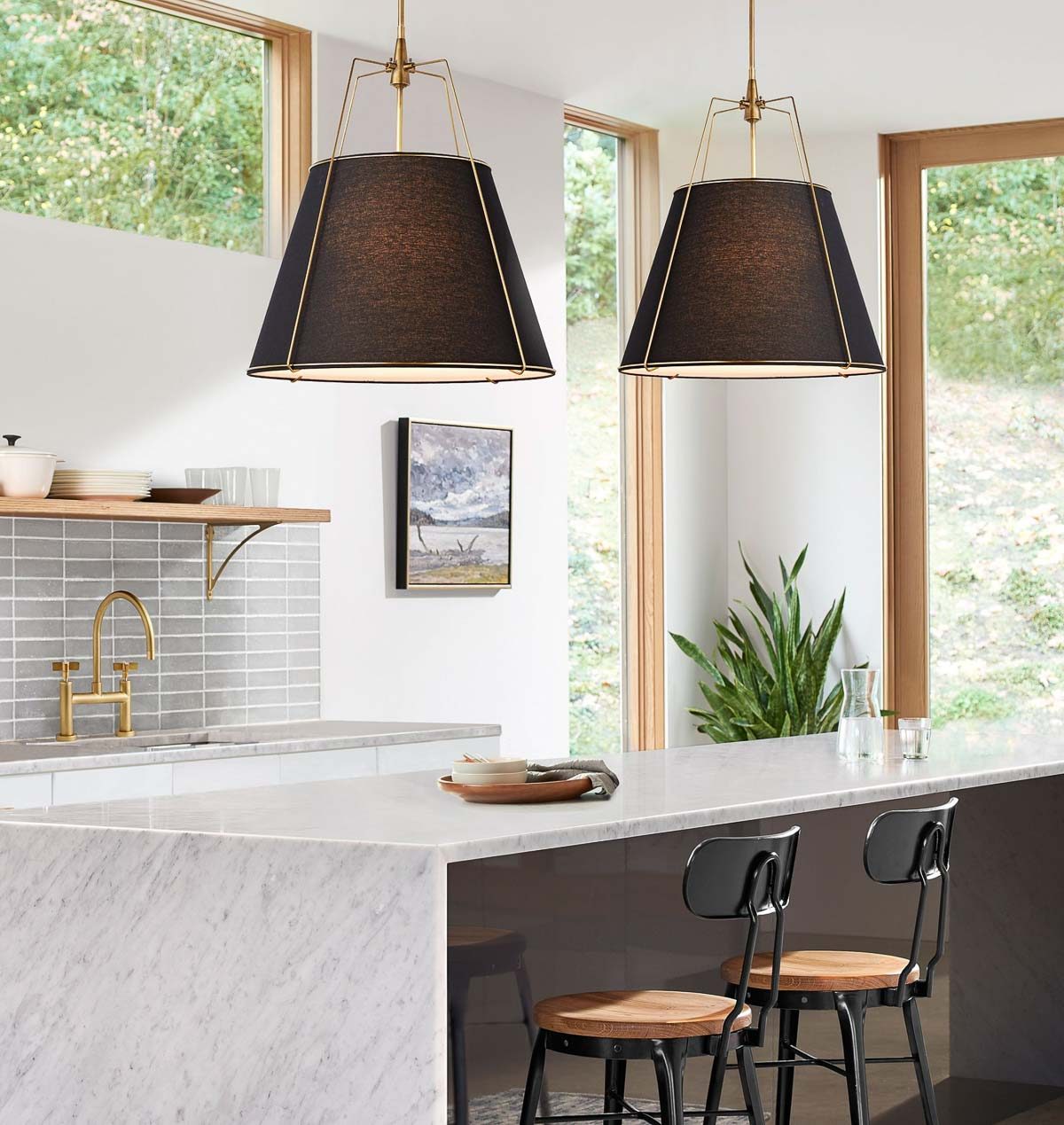 Pair of drum-shaped black cone pendants over a kitchen island