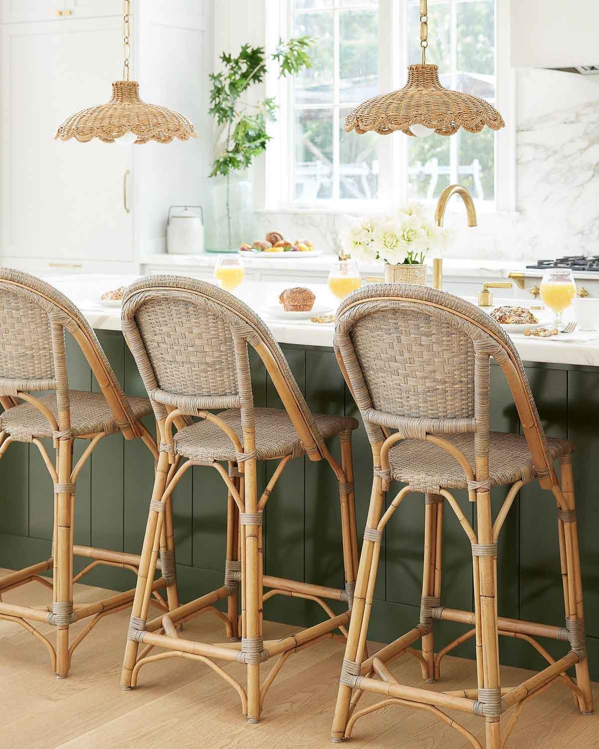 Two woven scalloped pendants hanging over kitchen island