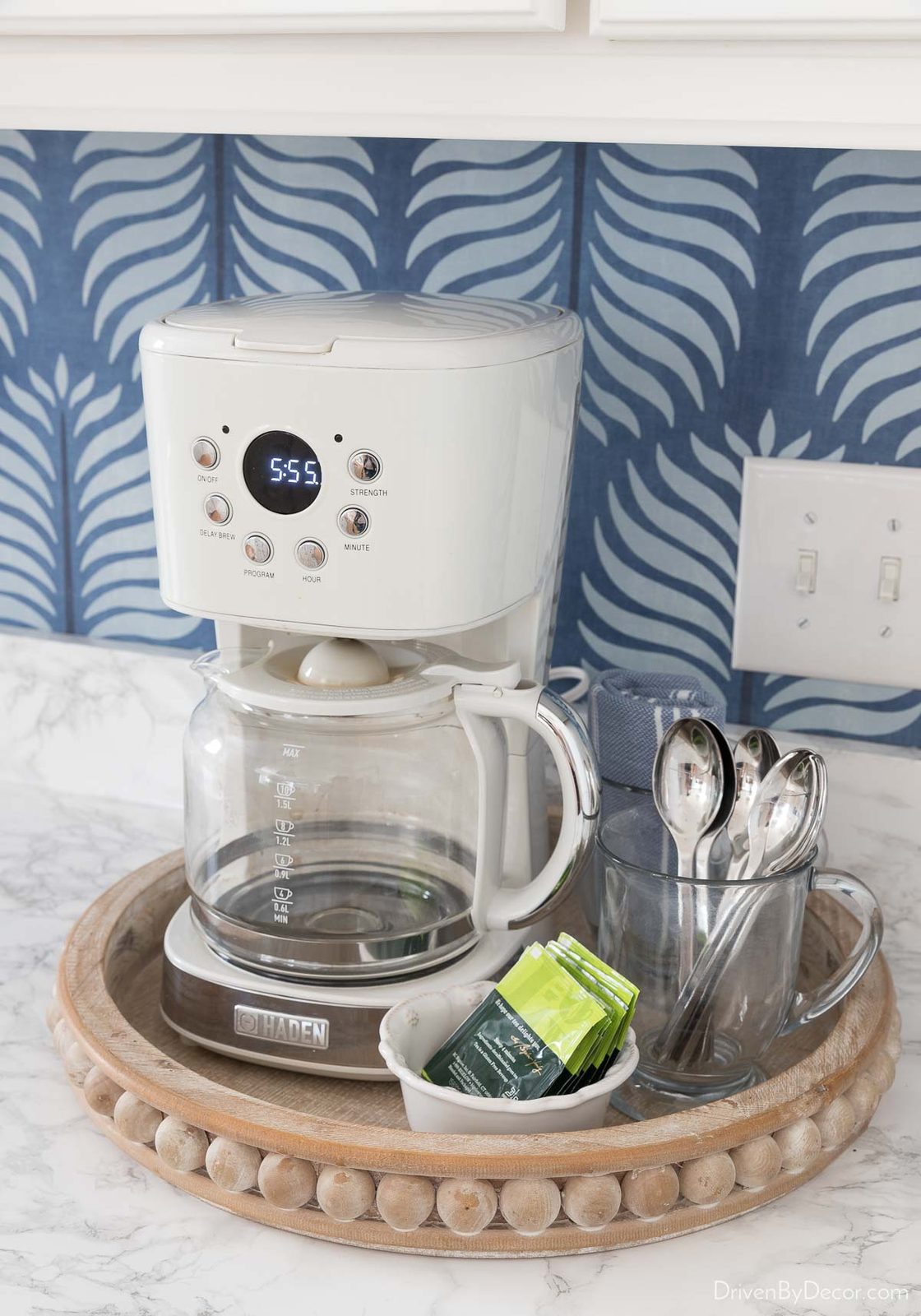 Our kitchen coffee maker in round wood beaded tray