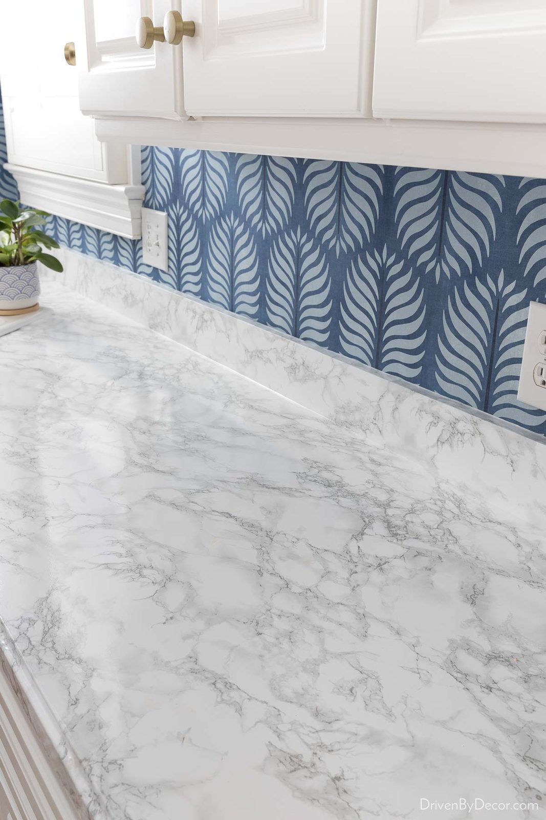 Adding contact paper to ugly countertops is an impactful kitchen remodel idea if you're on a budget!