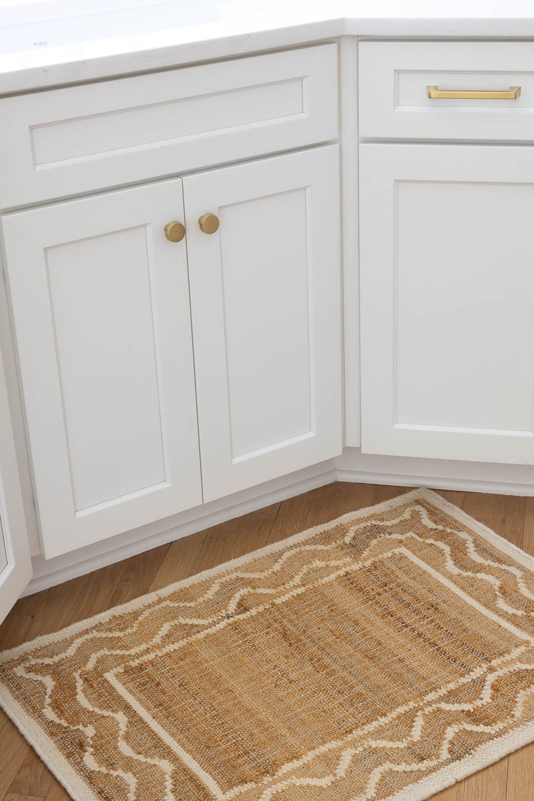 Woven rug in front of kitchen sink