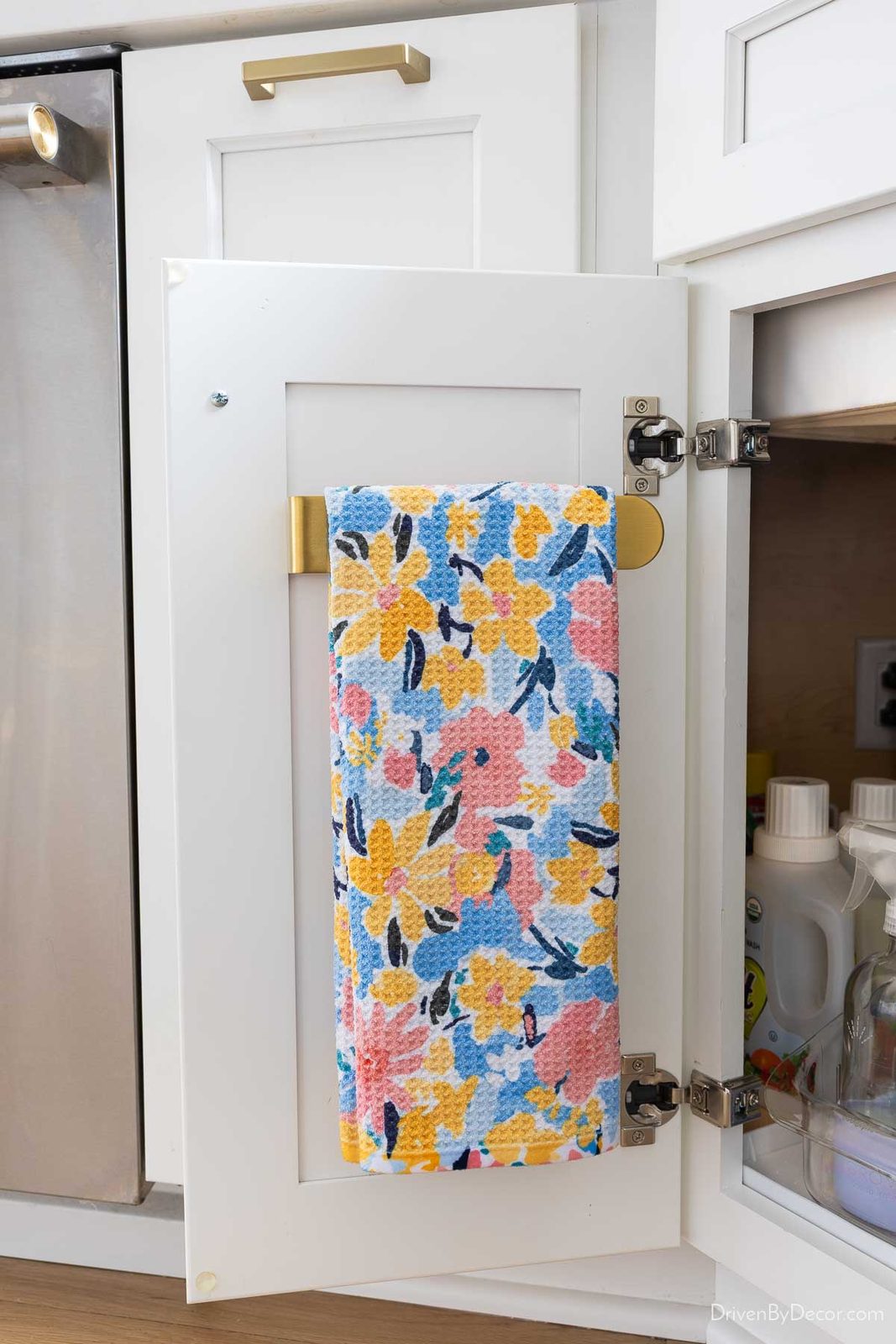 Dish towel hung on holder on inside of cabinet door