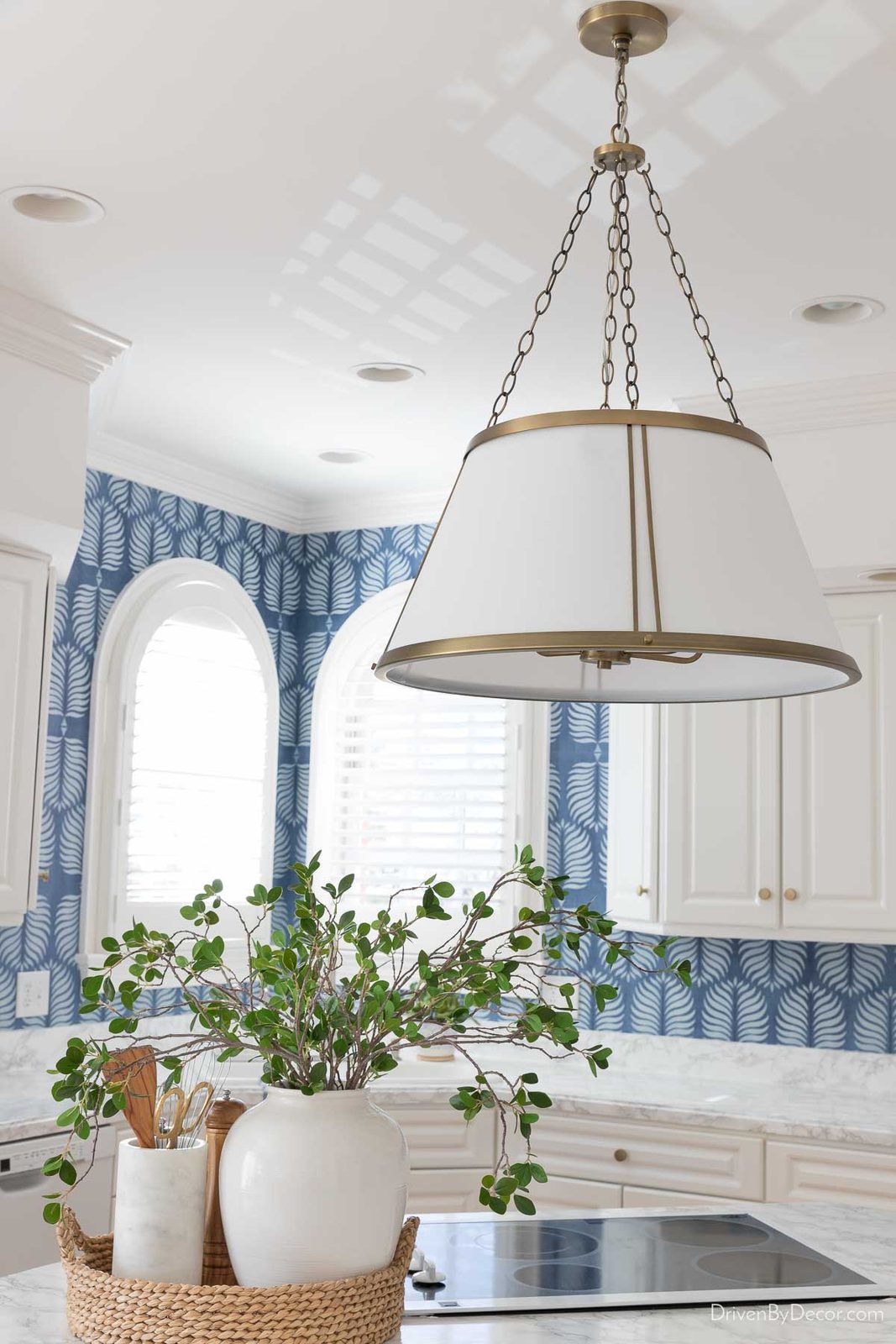 Large round pendant with brass accents as kitchen island lighting