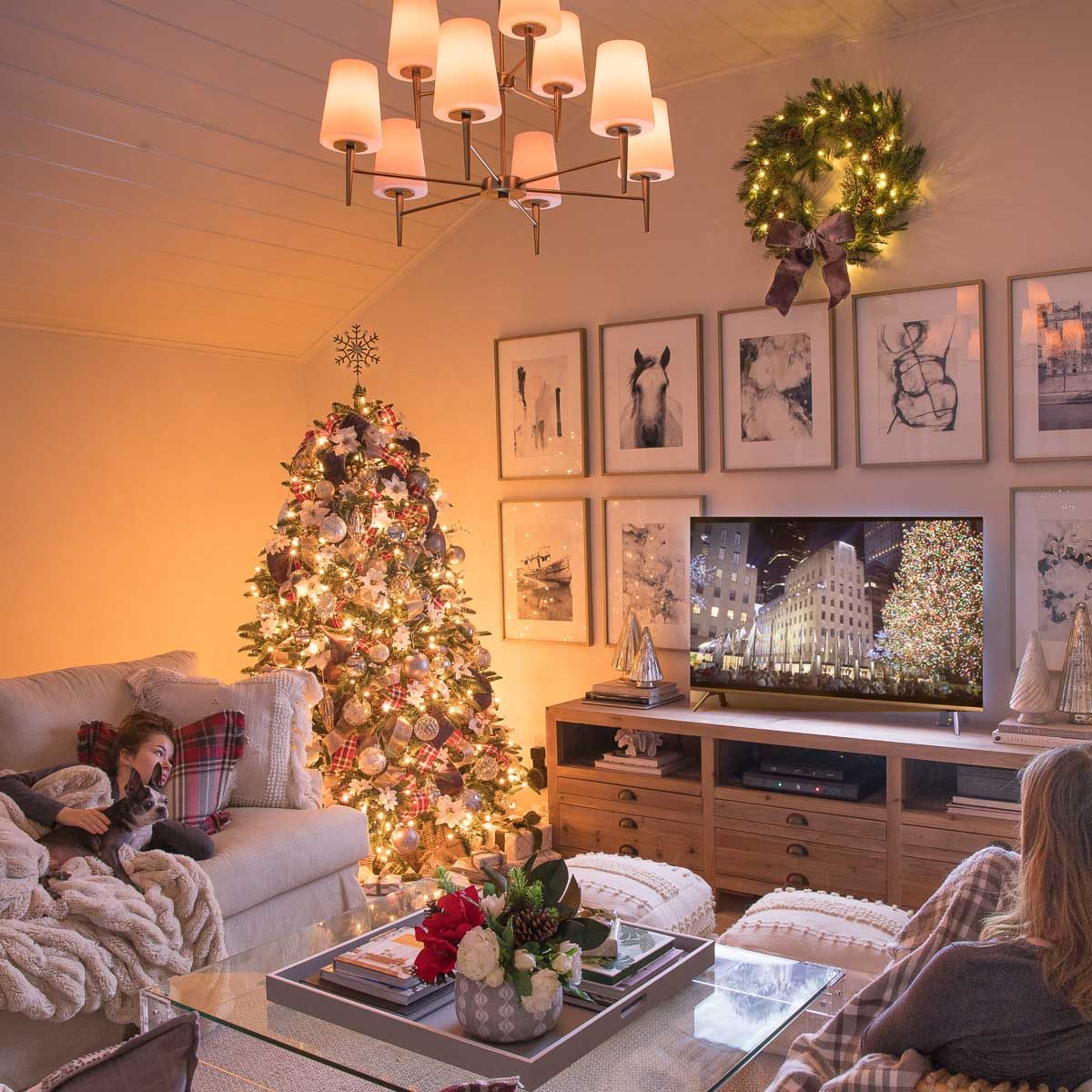 Family room decorated for Christmas with lit tree and chandelier