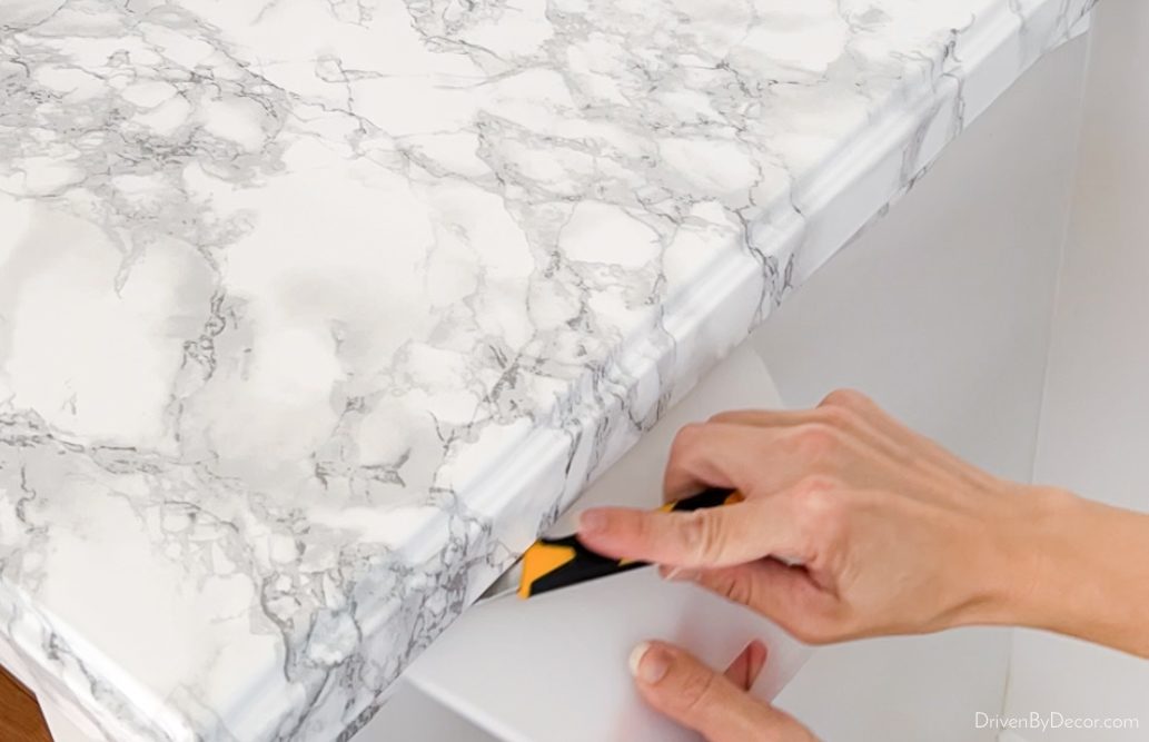 Trim off extra paper under countertop edge