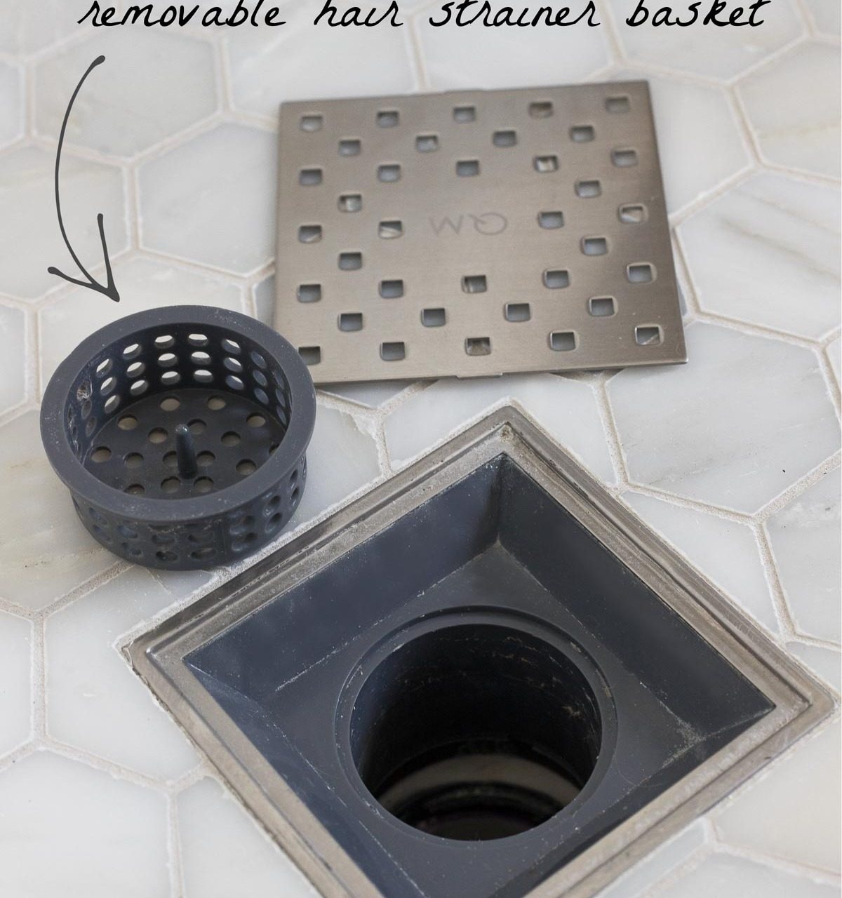 This shower drain has a removable hair strainer basket - such a smart master bathroom remodel idea!