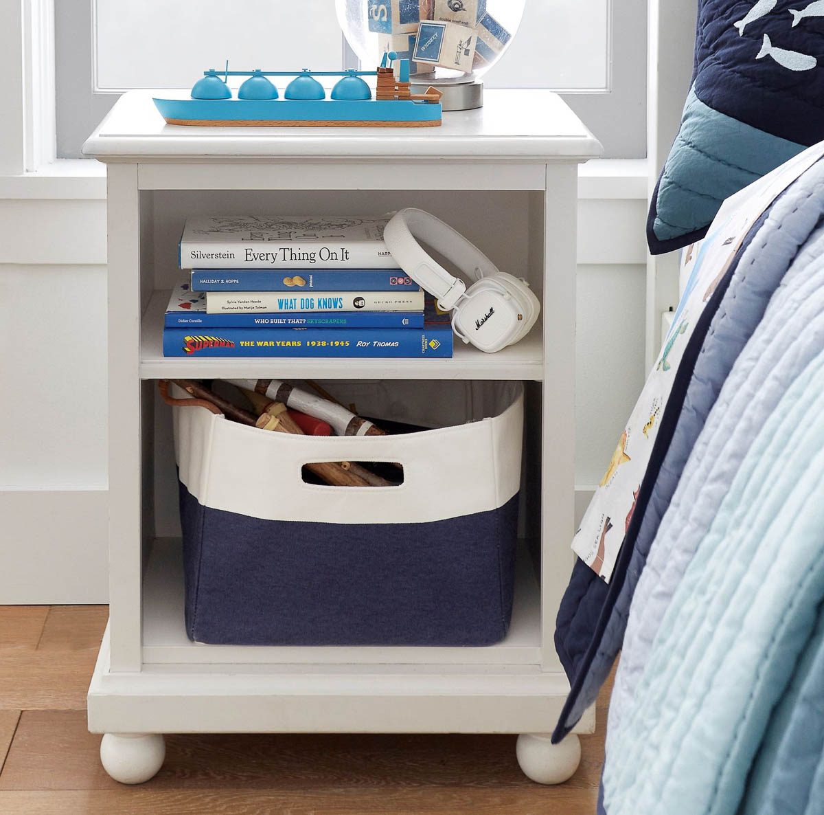 Basket holding toys in nightstand in child's bedroom
