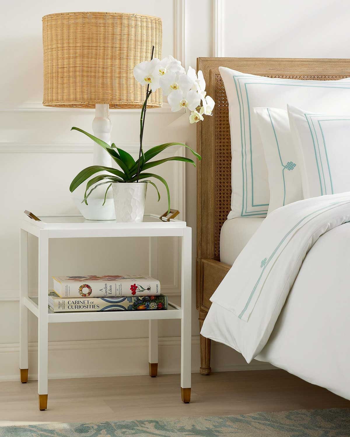 Orchid plant on nightstand next to lamp