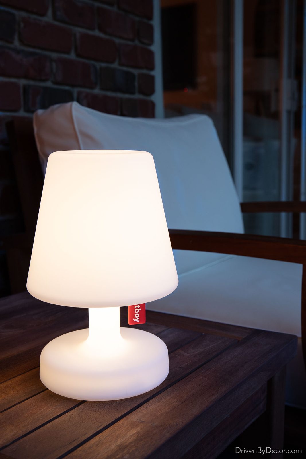 Portable rechargeable lamp on outdoor table