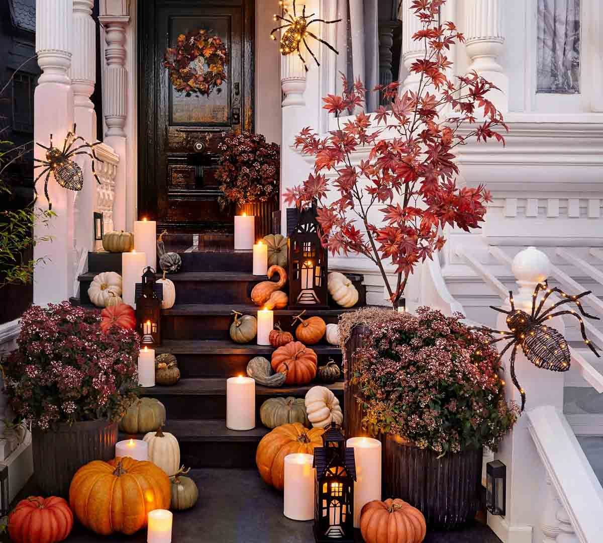 Faux pumpkins cascading down the steps of a fall front porch